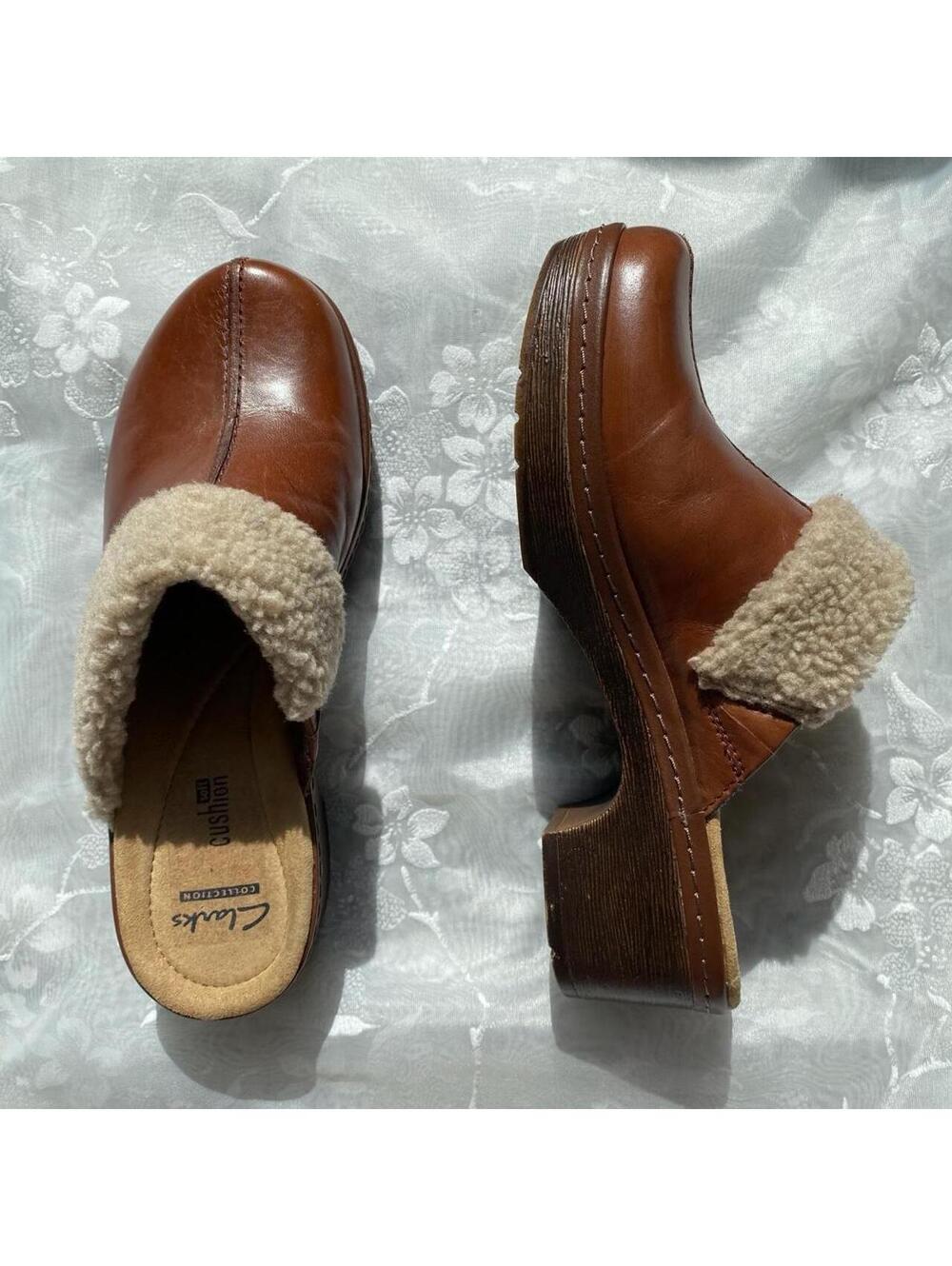Brown leather clogs with cream shearling lining,